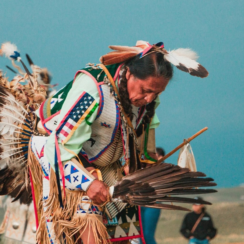 tribal-woman-wearing-feather-props-immersive-cultural-travel-experiences